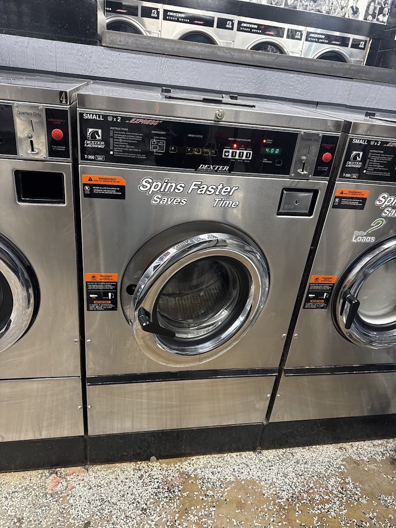 Row of Dexter commercial front-load washing machines at Dirty Franky's Laundromat
